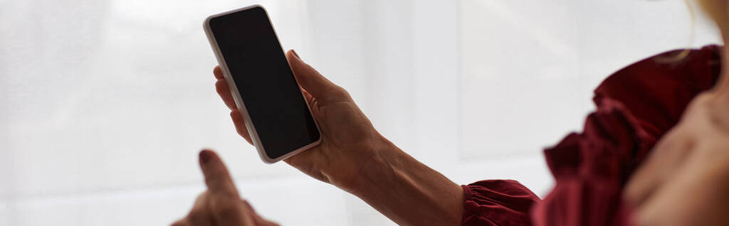 stock-photo-mature-woman-striking-red-dress-holding-cellphone